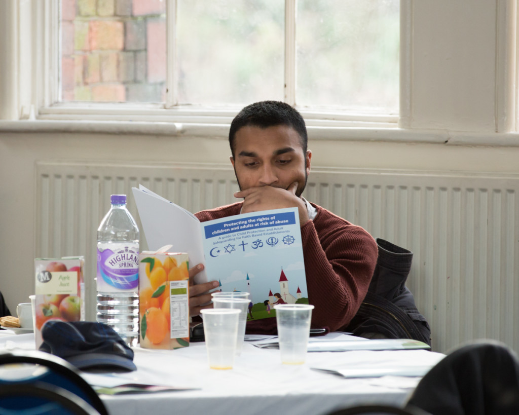 An Individual at the event reading the Safeguarding Guide