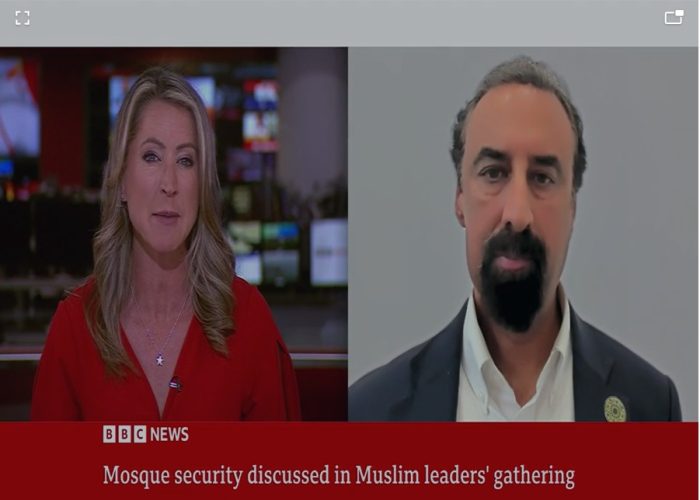 BBC News presenter interviewing a Faith Associates representative about mosque security